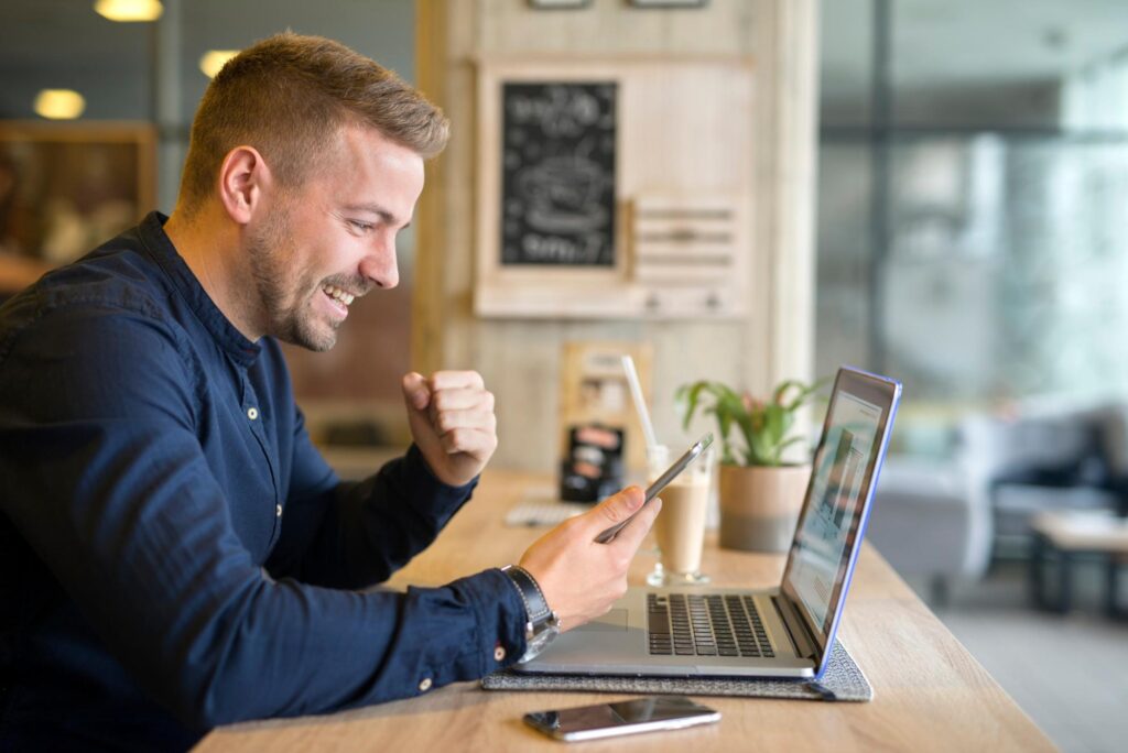 happy-freelancer-with-tablet-laptop-computer-coffee-shop